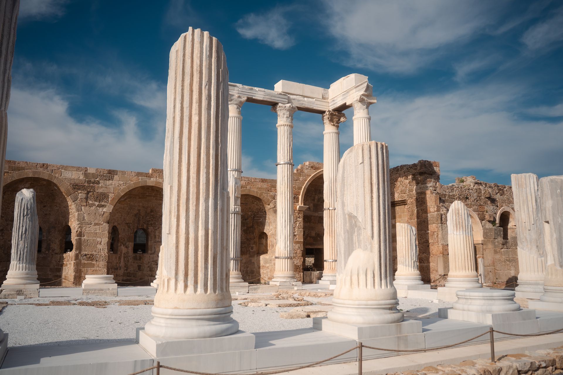 Explore the well-preserved ancient Roman ruins in Side, Antalya, Türkiye, shining under a clear blue sky.