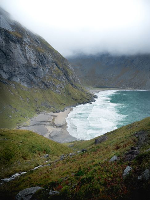 Discover the tranquility of Nordland's hidden beach with stunning cliffs and gentle waves.