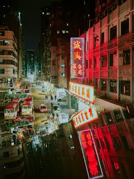 Colorful neon lights and reflections on a rainy night in vibrant Hong Kong streets.