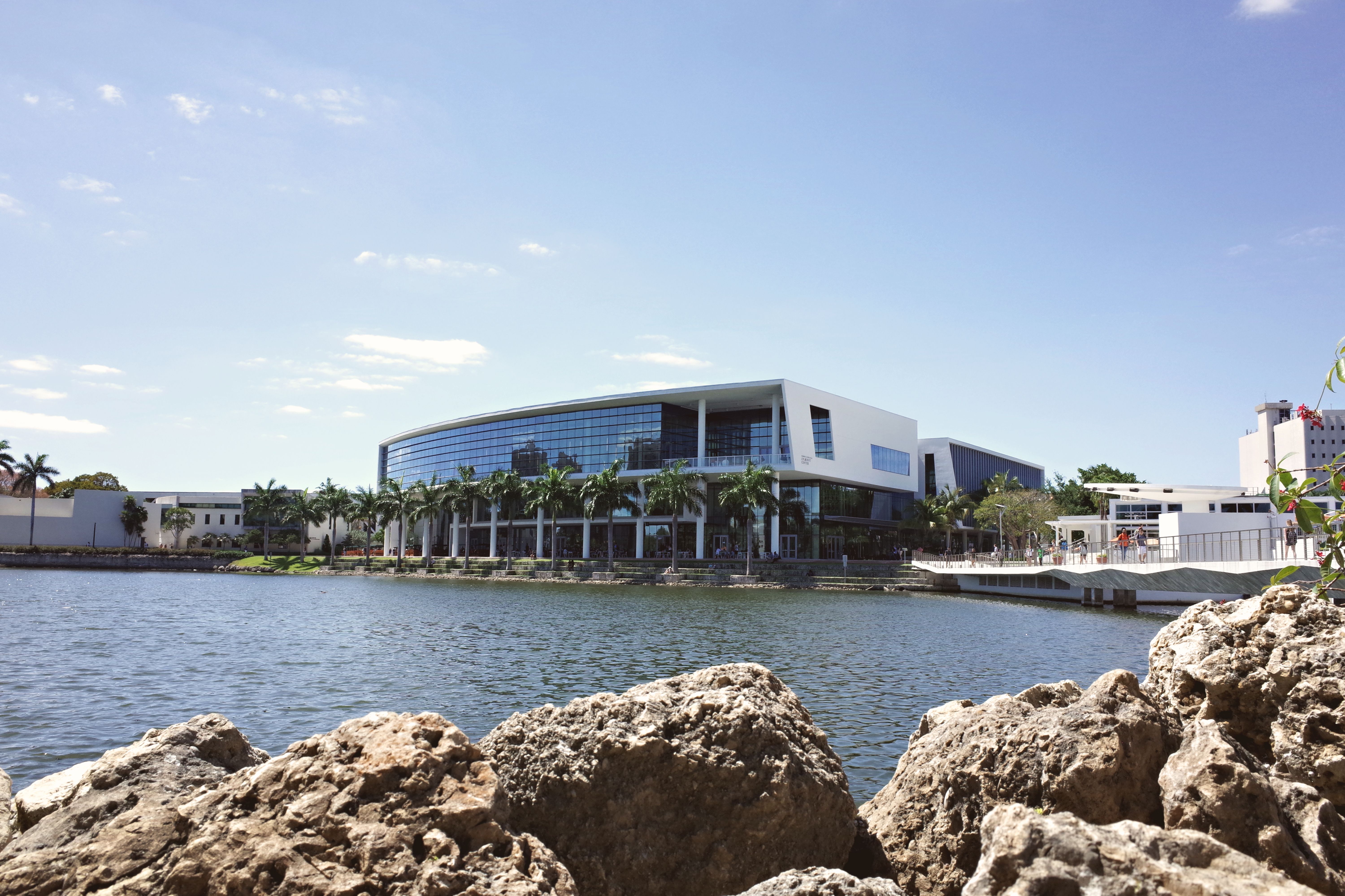 Modern university campus building by a tranquil lake in Coral Gables, Florida