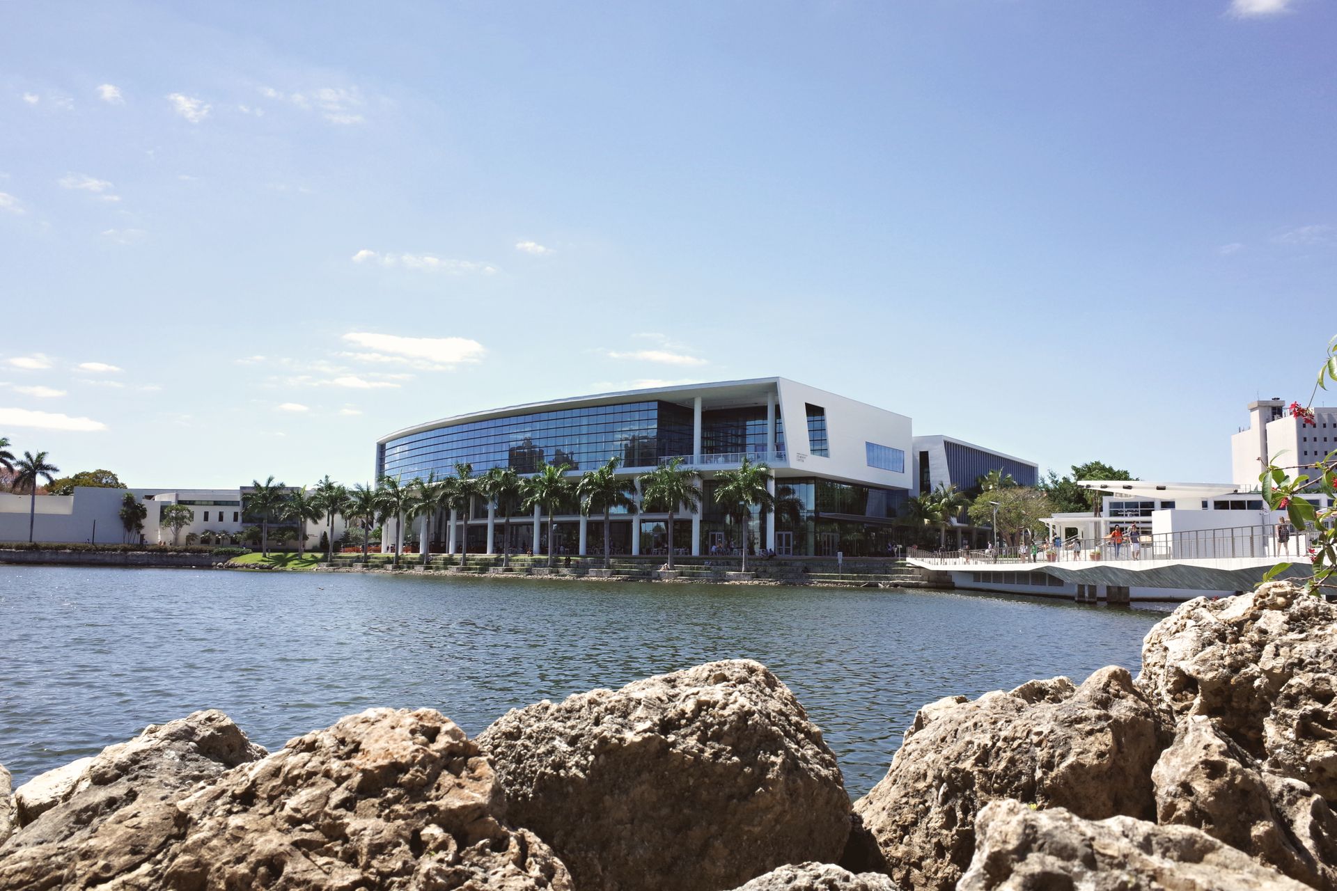 Modern university campus building by a tranquil lake in Coral Gables, Florida