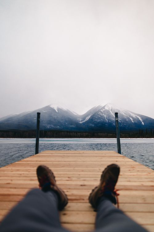 Banff Dock Relaxing on a Dock with Mountain View in Banff · Free Stock Photo