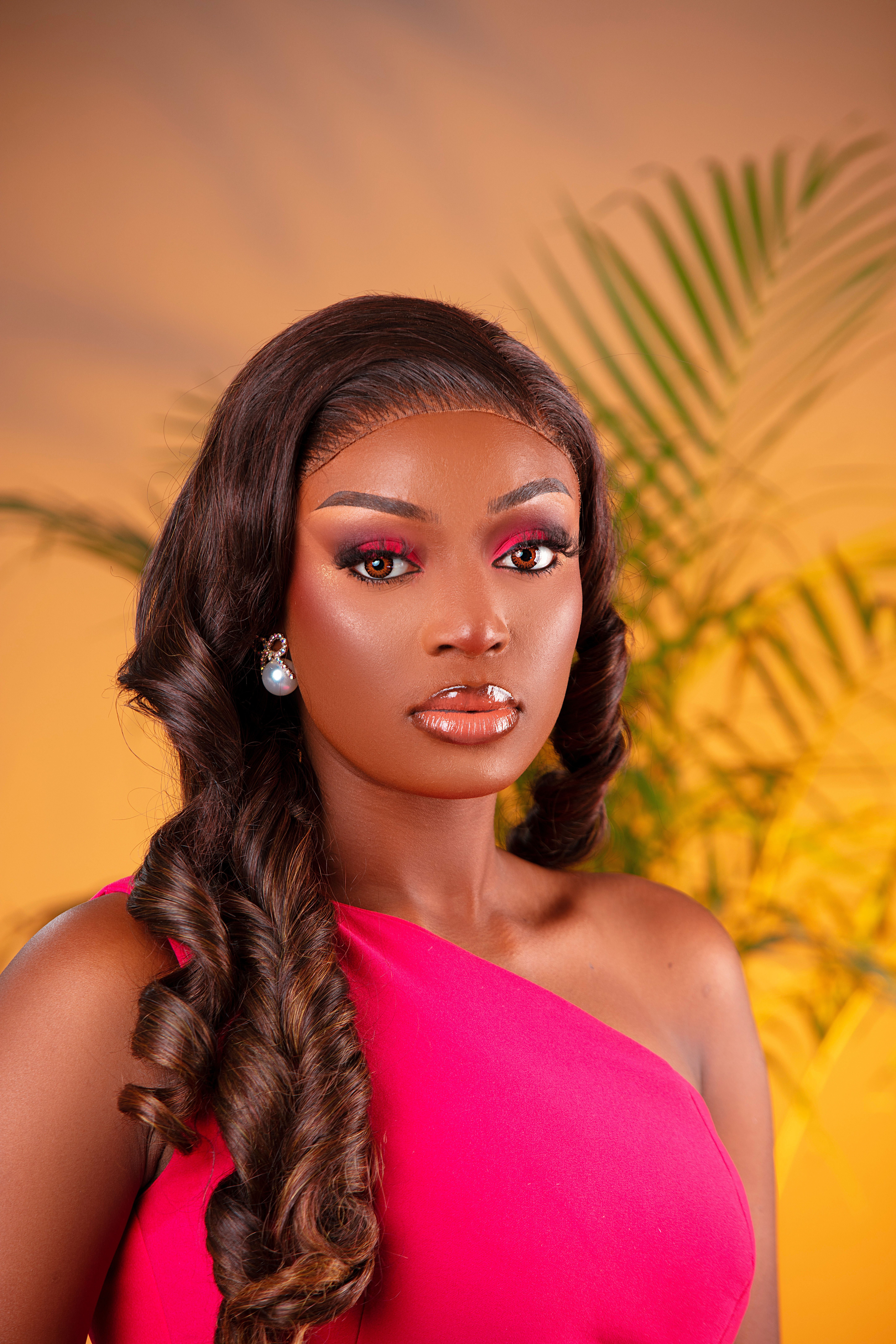 A portrait of an elegant woman in a pink dress with stylish makeup and lush backdrop. Perfect for fashion and beauty themes.