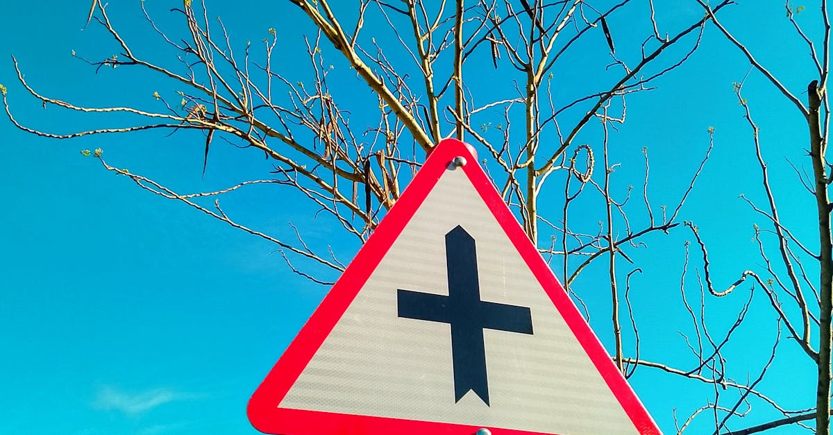 Triangular Traffic Sign Against Blue Sky · Free Stock Photo
