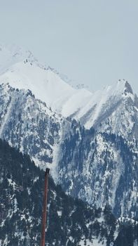 Majestic snow-capped mountains in Sonamarg, Kashmir captured on a serene winter day.