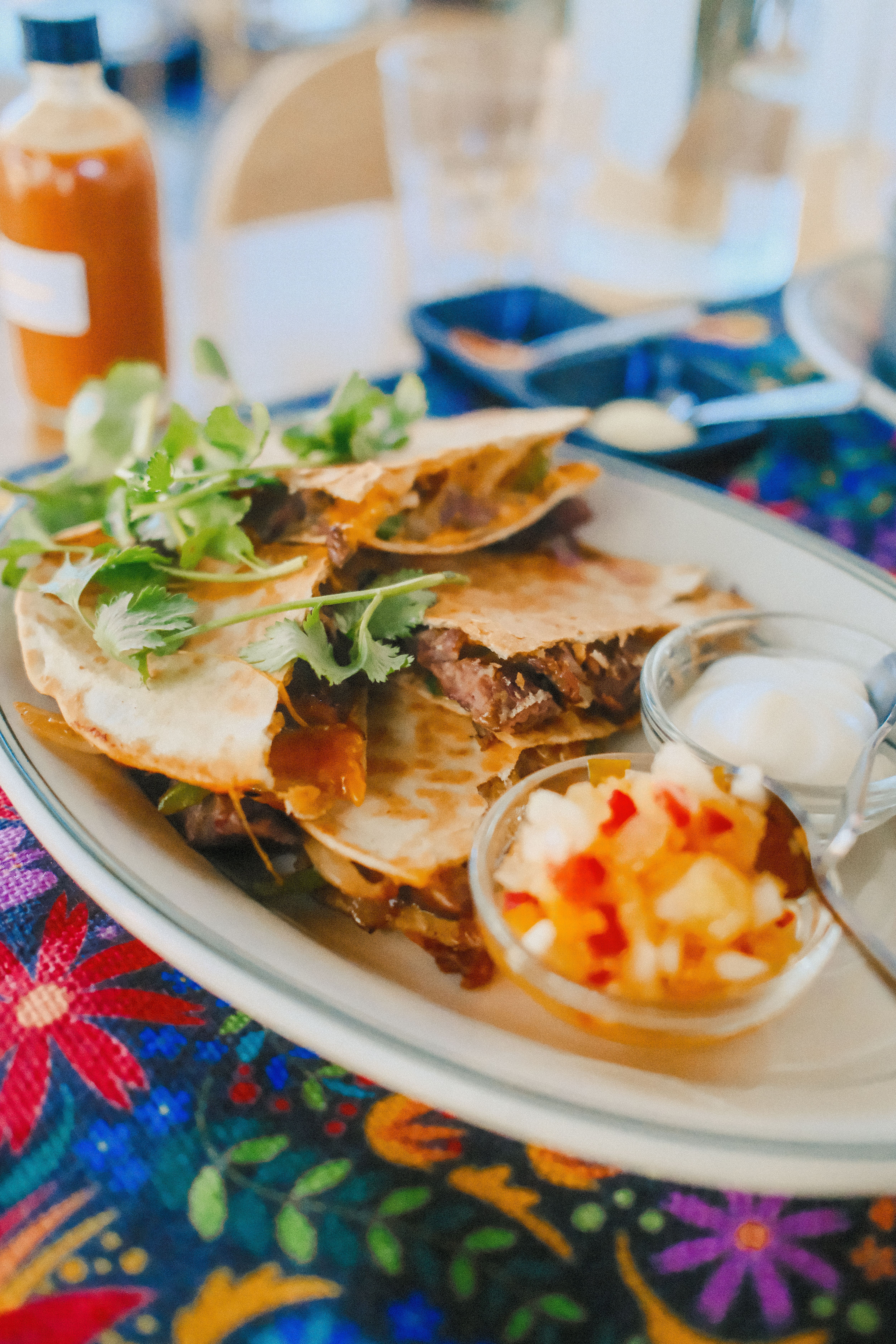 Golden beef quesadilla wedges served with salsa and sour cream