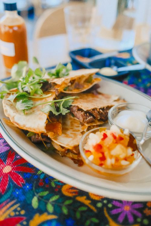 Golden beef quesadilla wedges served with salsa and sour cream