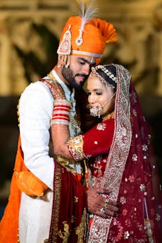 A beautiful moment of a couple embracing at a traditional Indian wedding.