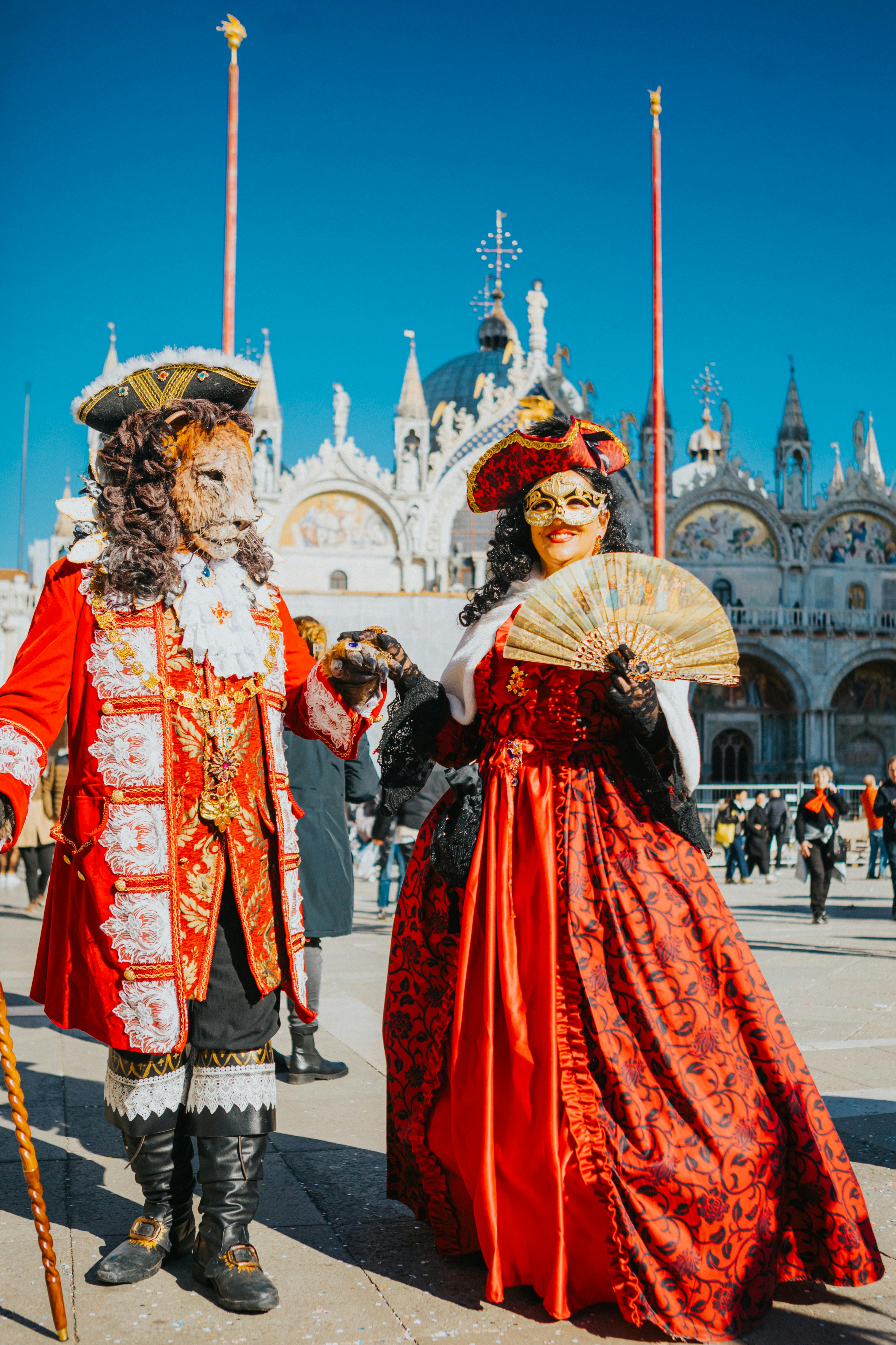 Colorful Venetian carnival masks and costumes in St. Mark's Square, Venice, during the festive carnival.