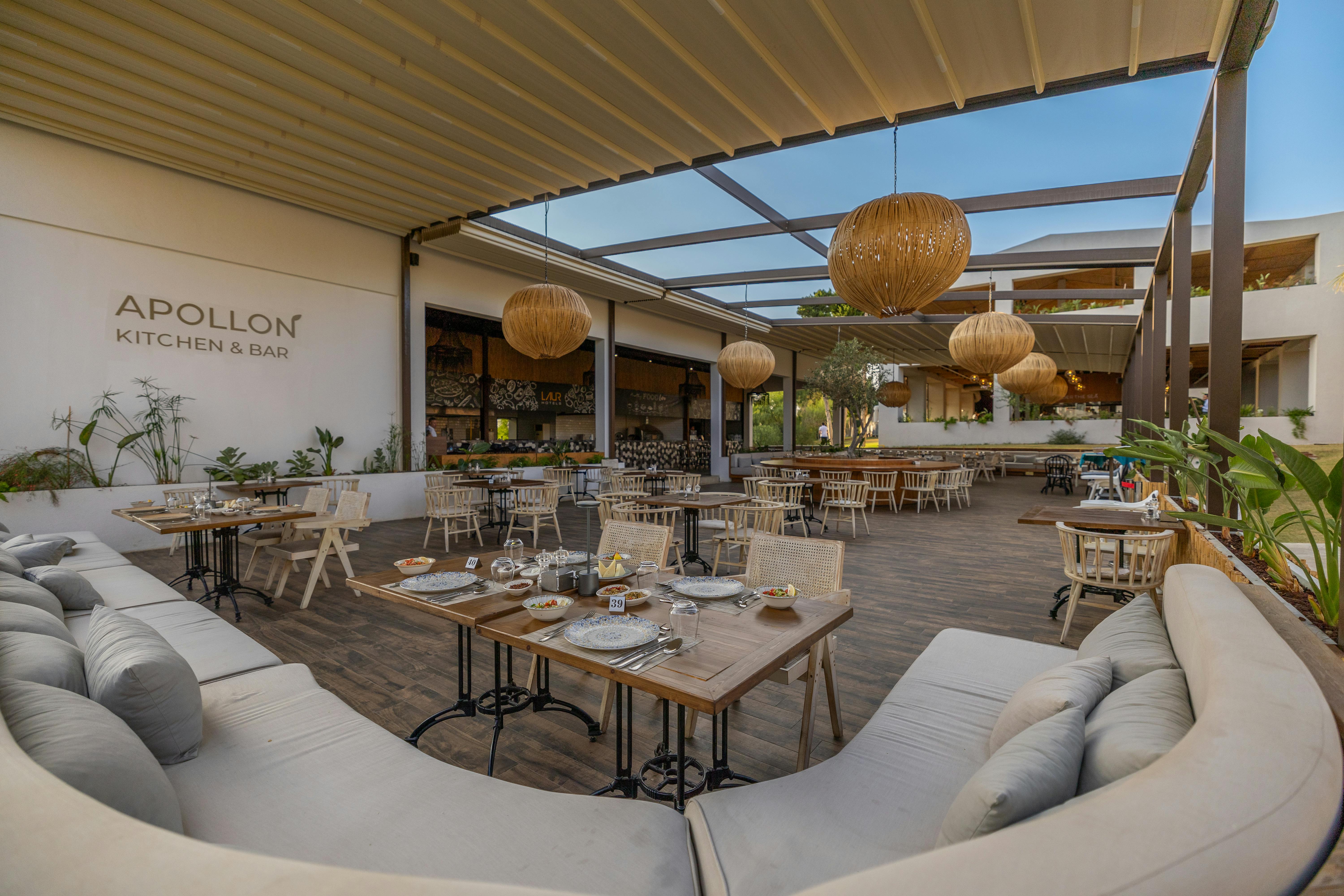 Experience elegant outdoor dining at Apollon Kitchen & Bar in Didim, Türkiye, with stylish decor and ambiance.