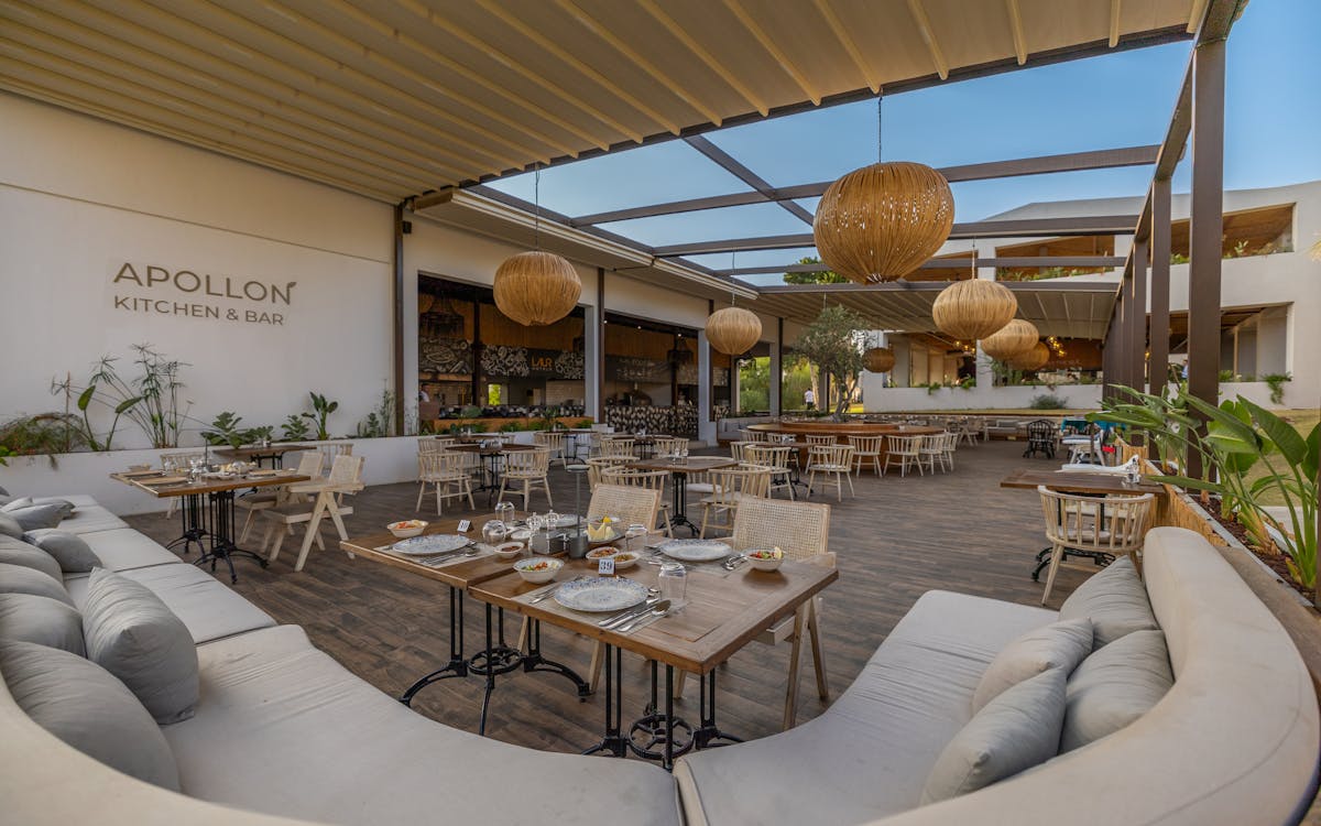 Experience elegant outdoor dining at Apollon Kitchen & Bar in Didim, Türkiye, with stylish decor and ambiance.