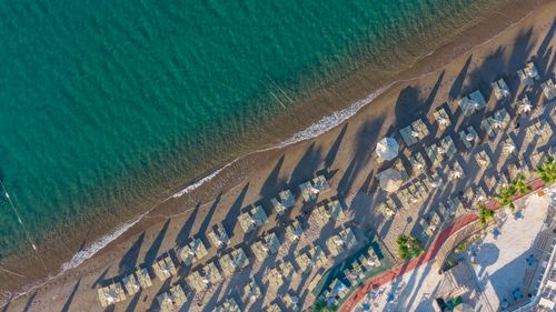 Free Aerial shot of Bodrum beach in Turkey with sun umbrellas casting shadows. Stock Photo