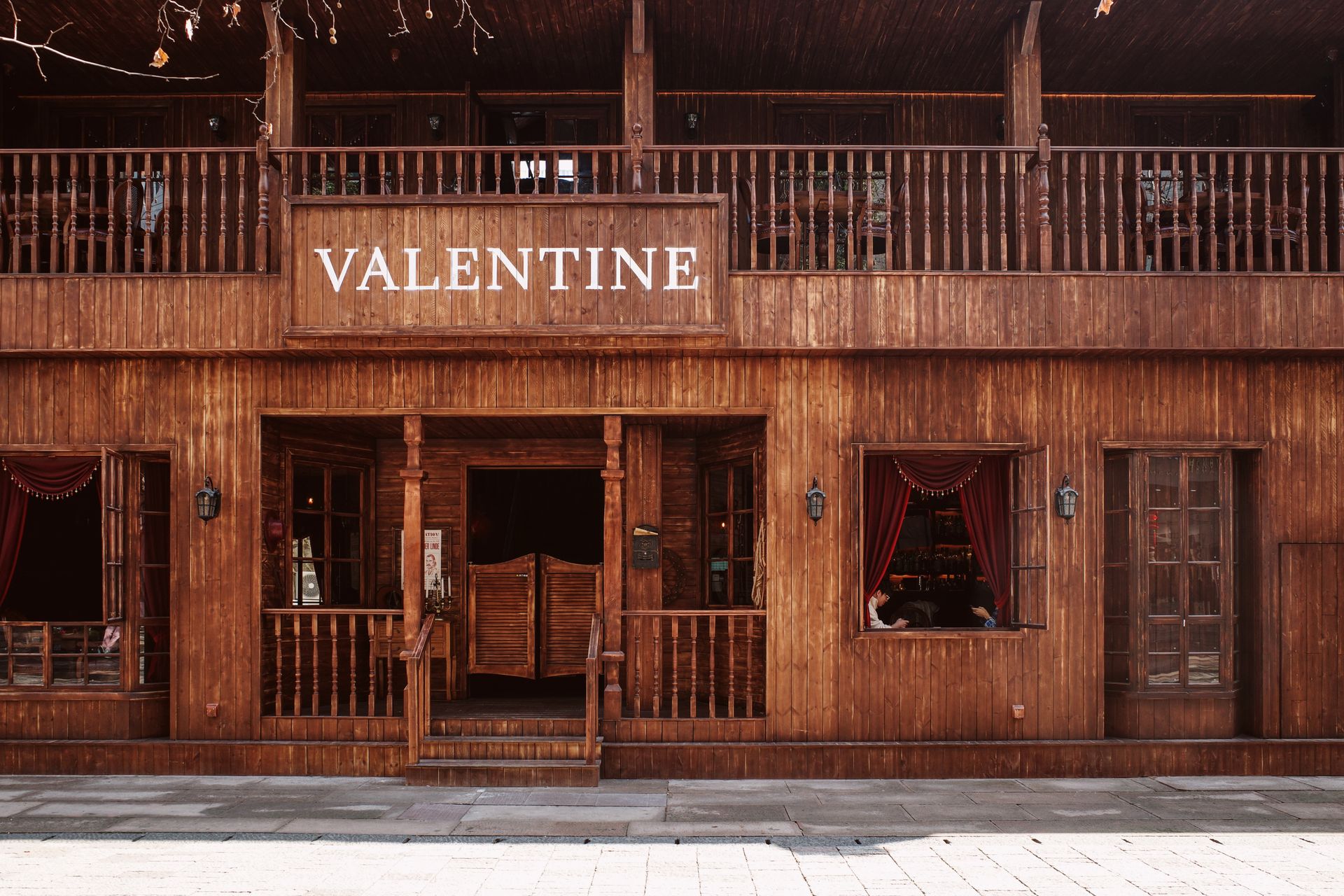 Vintage wooden saloon facade with VALENTINE sign, evoking a classic Western atmosphere.
