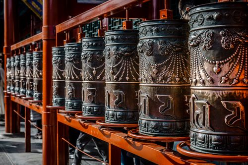 Free Beautifully crafted prayer wheels in a Beijing temple, highlighting intricate designs and cultural spirituality. Stock Photo