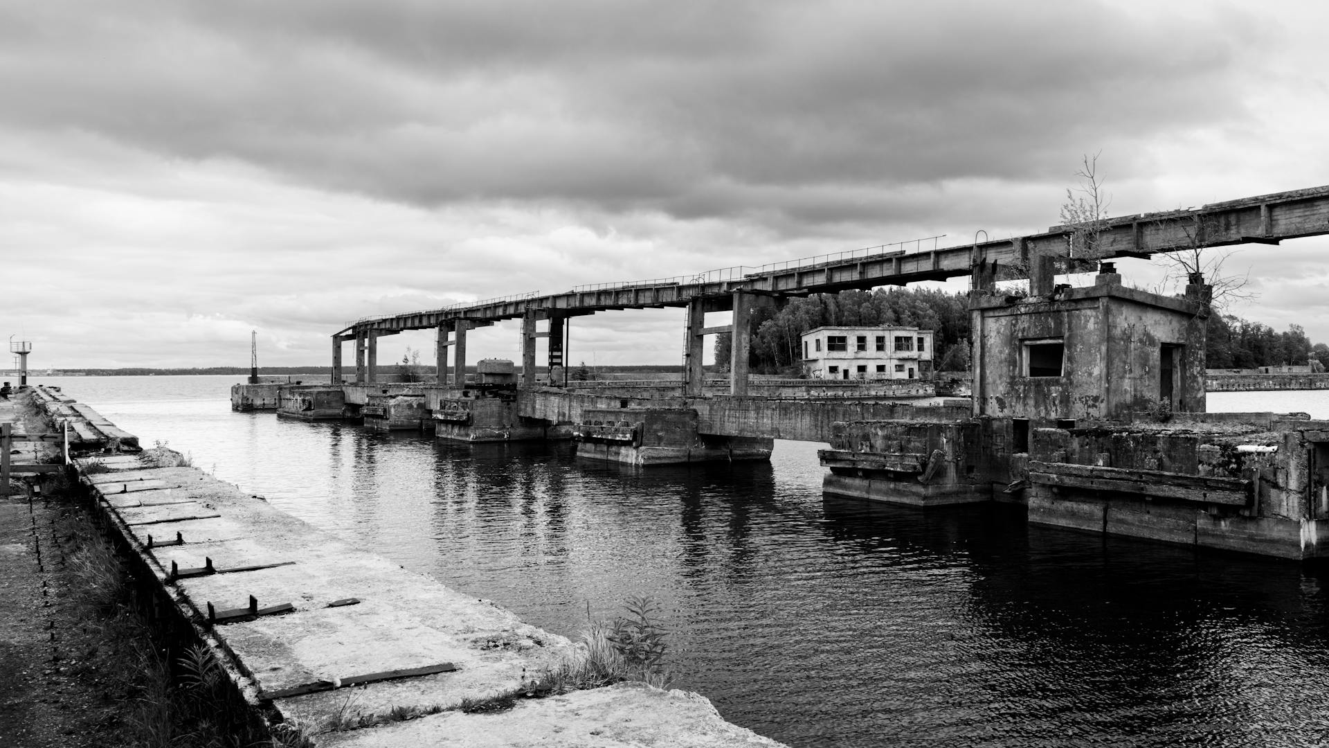 Black and white photo of abandoned Soviet submarine base in Hara, Estonia, overcast sky.
