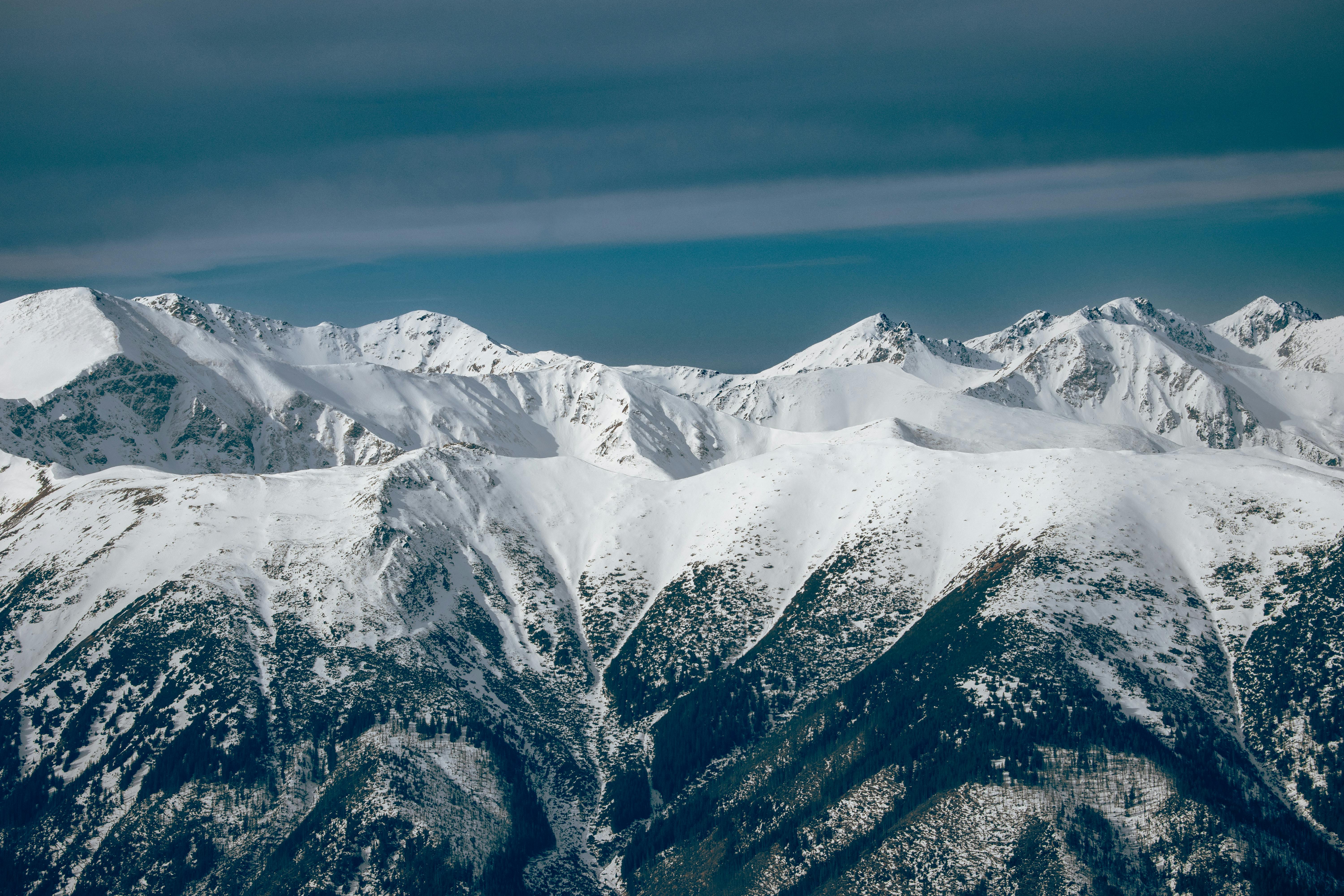 Breathtaking view of the snow-covered Tatra Mountains under a clear blue sky.