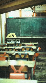 A vintage classroom with a chalkboard, wooden desks, and traditional décor.