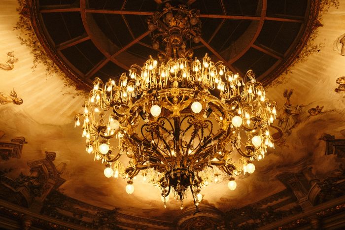 Opulent gilded chandelier in a baroque ballroom — photo by Ramon Karolan on Pexels