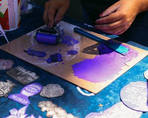 Purple ink rolled over a linocut plate — photo by sury Onaly on Pexels