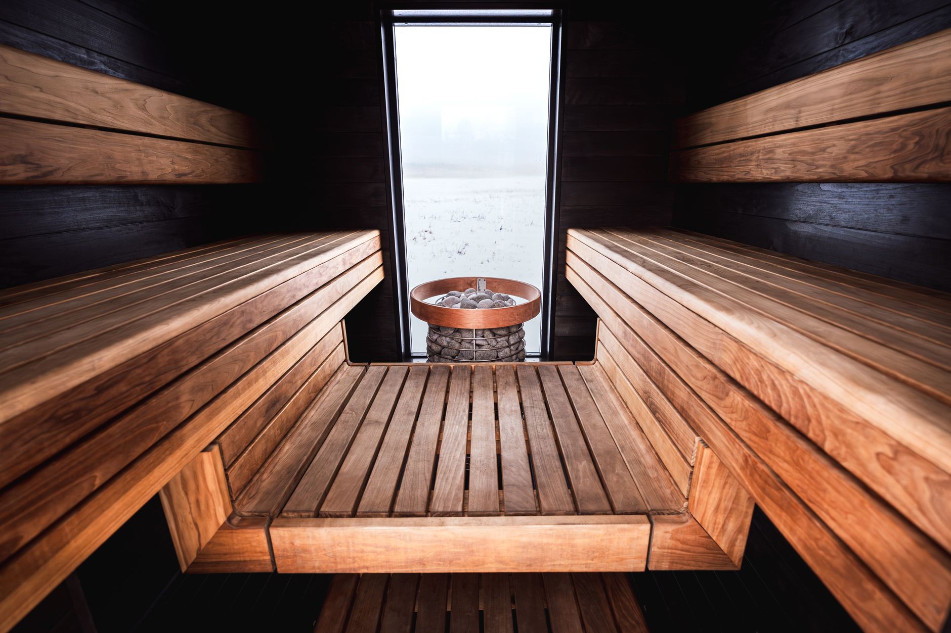 Person enjoying a sauna session after a workout, with a towel around their neck.