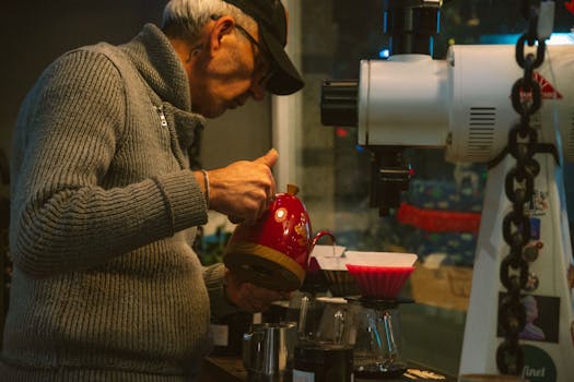 Barista expertly preparing pour over coffee with precision and care in a cozy cafe setting.