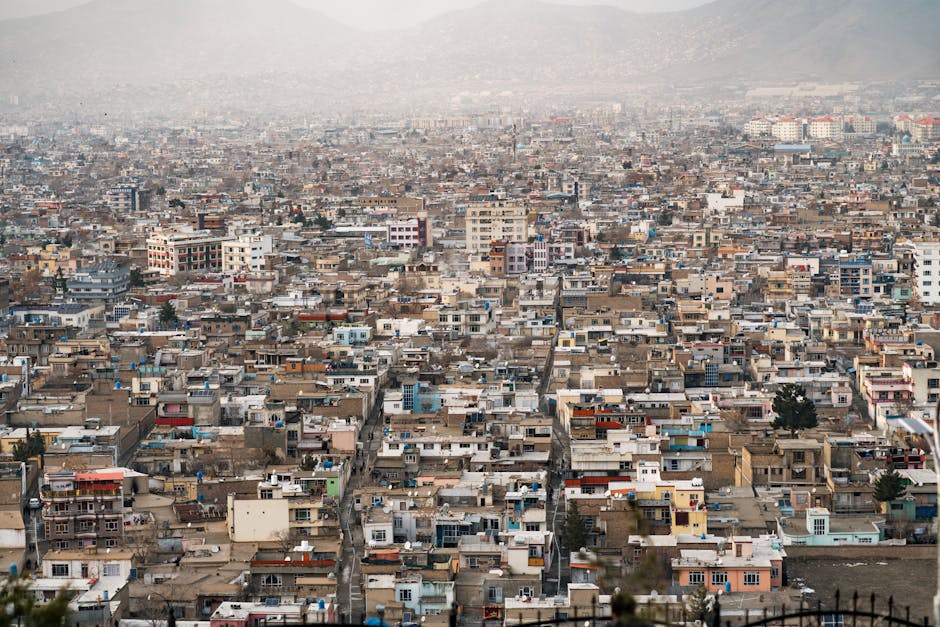 Expansive aerial view of Kabul city, showcasing urban density and surrounding mountains in Afghanistan.