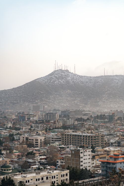 Free A panoramic view of Kabul city with the mountain range in the background under a cloudy sky. Stock Photo