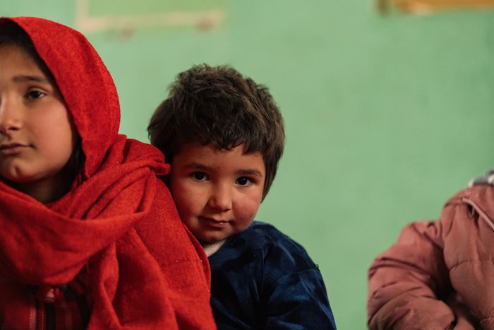 Afghan girls and boys in a learning space
