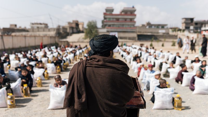 Crowd gathered for a humanitarian aid distribution event in Afghanistan.