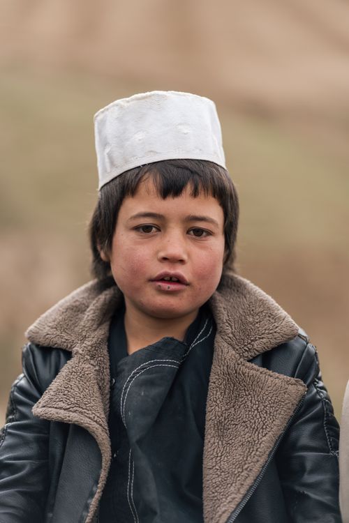 Free A young child wearing traditional Afghan attire, outdoors in Afghanistan. Stock Photo