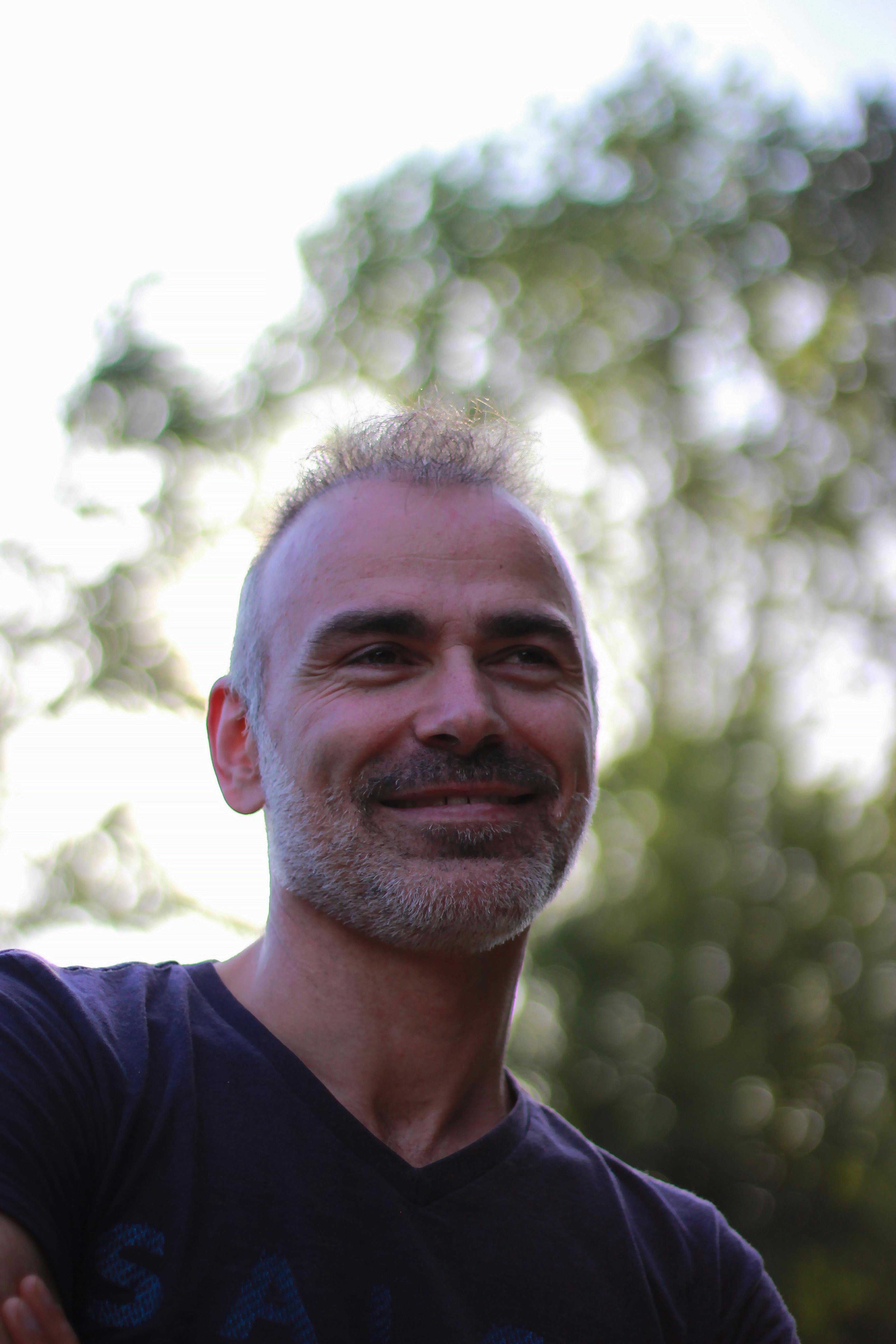 A cheerful man enjoys a sunny day outdoors in Braga, Portugal.
