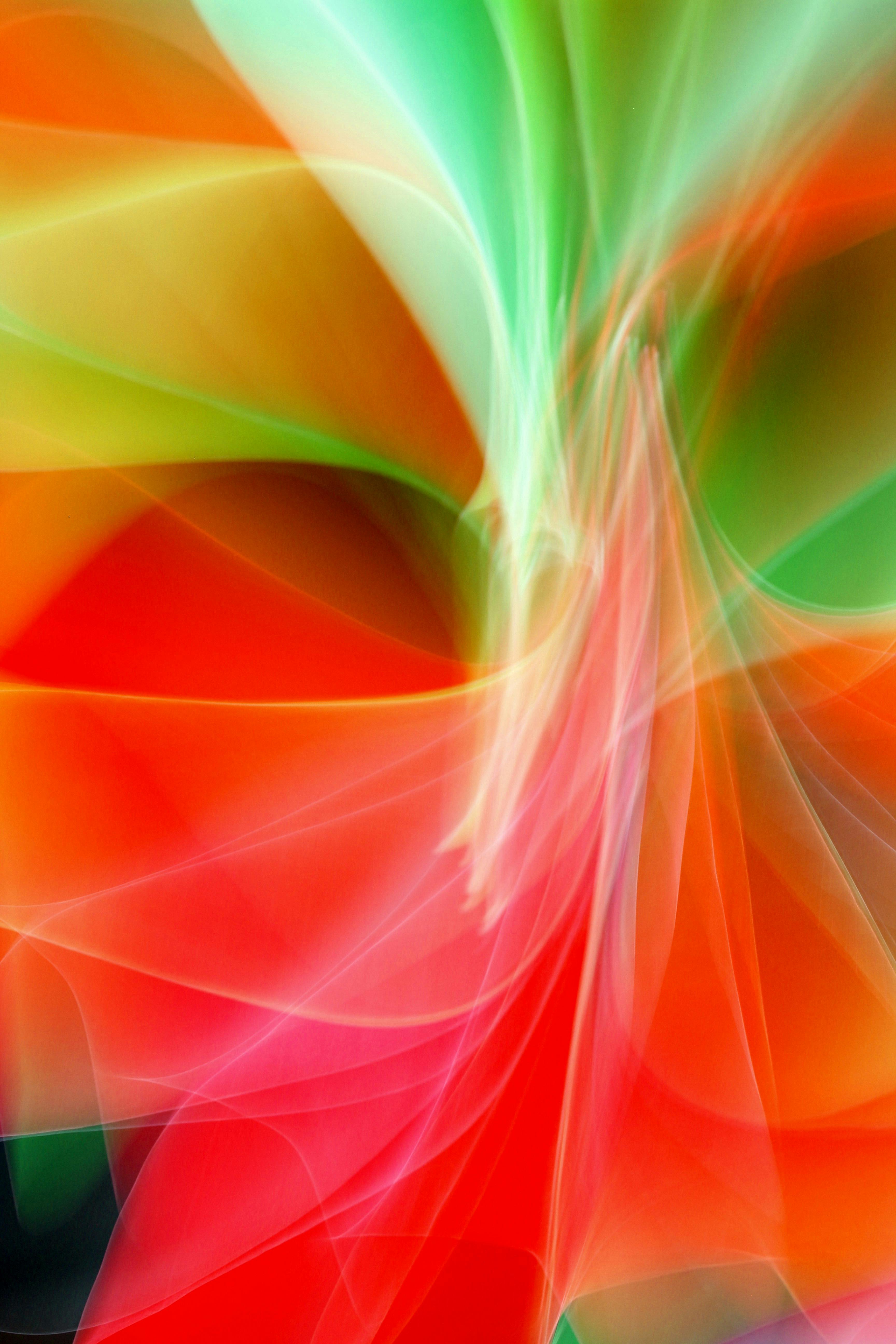 Vibrant abstract art featuring swirling red and green colors creating a dynamic visual effect.
