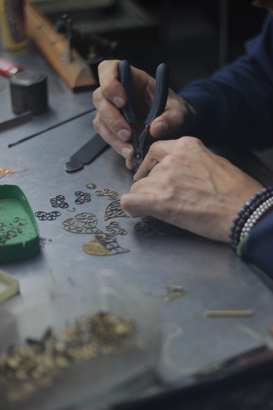Artisan's hands designing gold jewelry