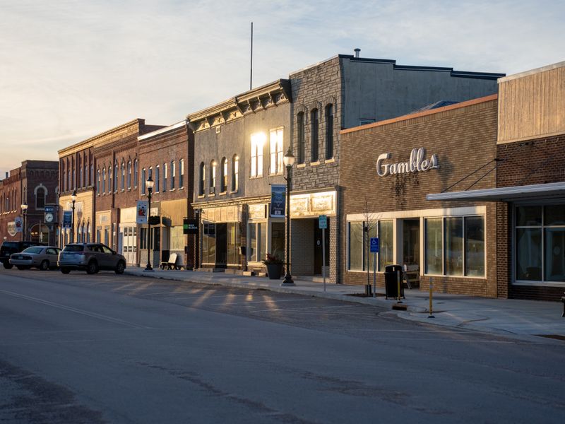 Historic storefronts on a small-town street at sunset