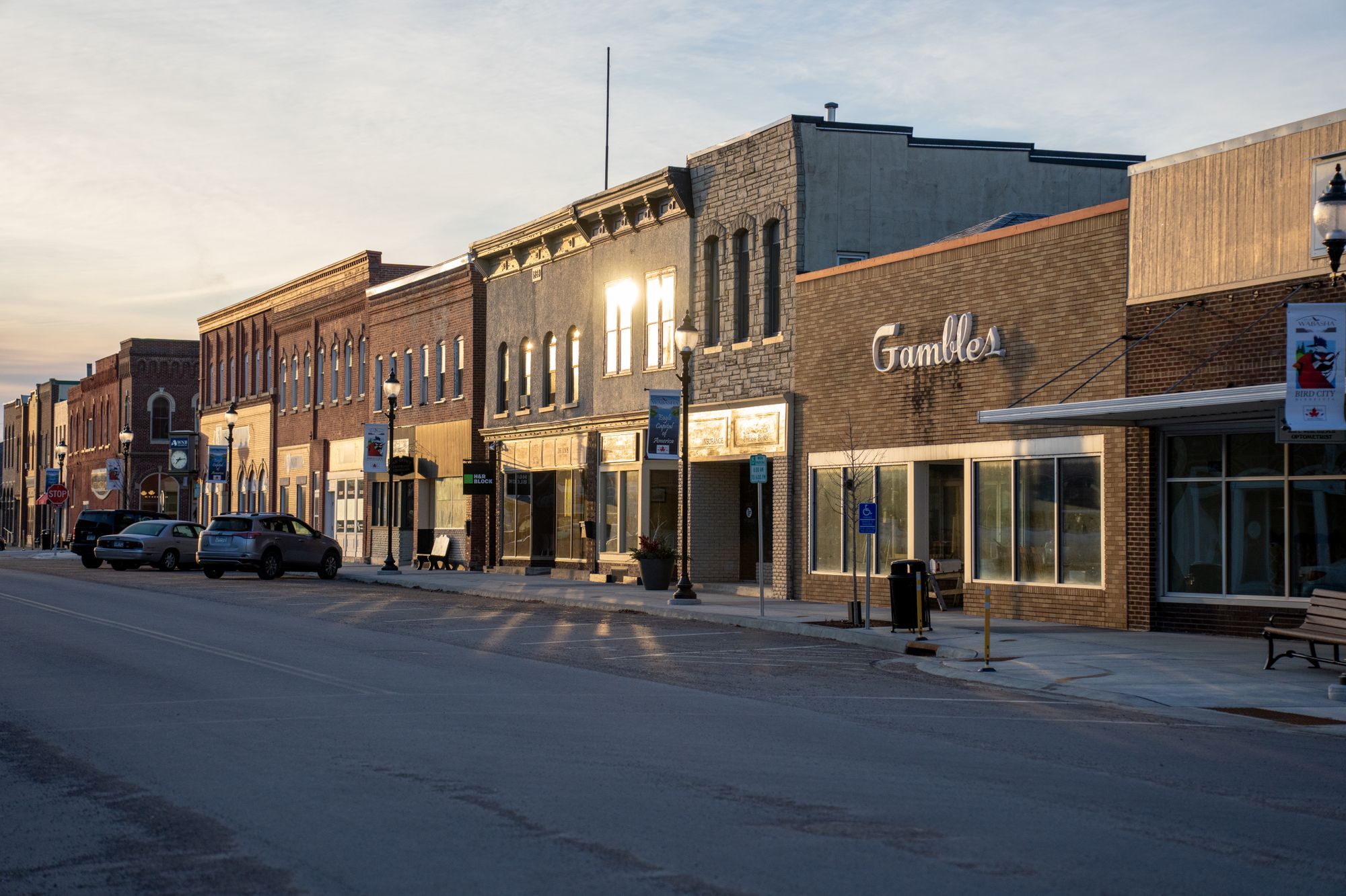 Historic main street storefronts glowing at sunset