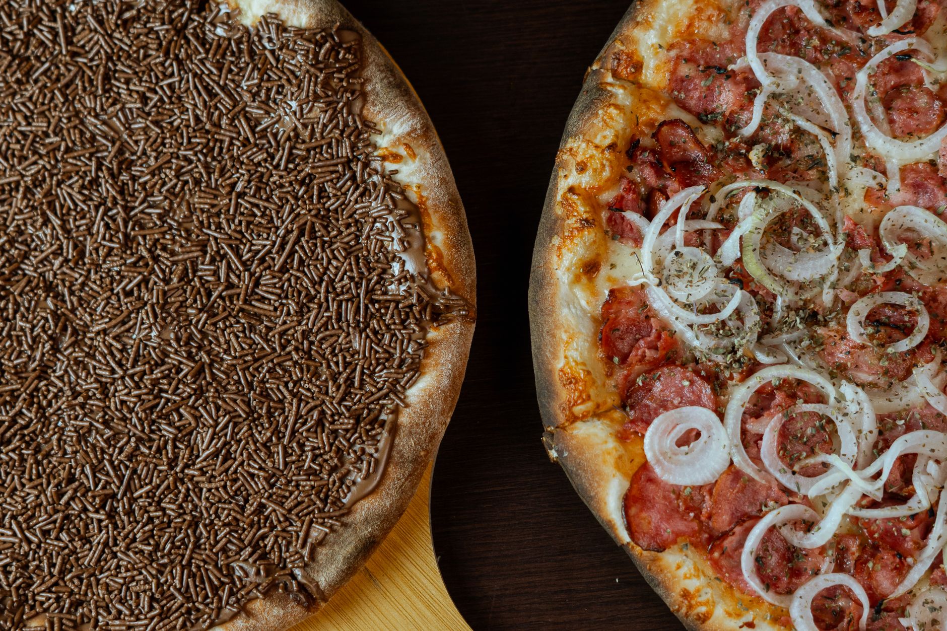 Close-up of a roasted carrot pizza slice with herbs