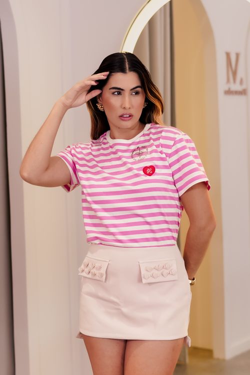 Free Stylish woman modeling a pink striped t-shirt indoors. Perfect for fashion portfolios. Stock Photo