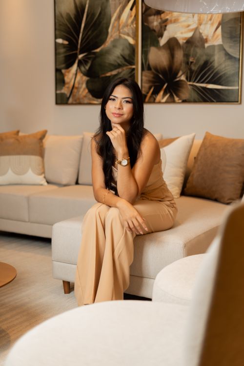 Free Stylish woman in chic living room with modern decor and neutral tones. Stock Photo