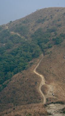 A winding hiking trail through a mountainous landscape — Nikita Grishin on Pexels