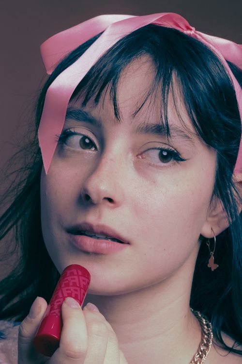 Free Elegant portrait of a woman with a pink bow and lipstick, capturing beauty and style in São Paulo, Brazil. Stock Photo