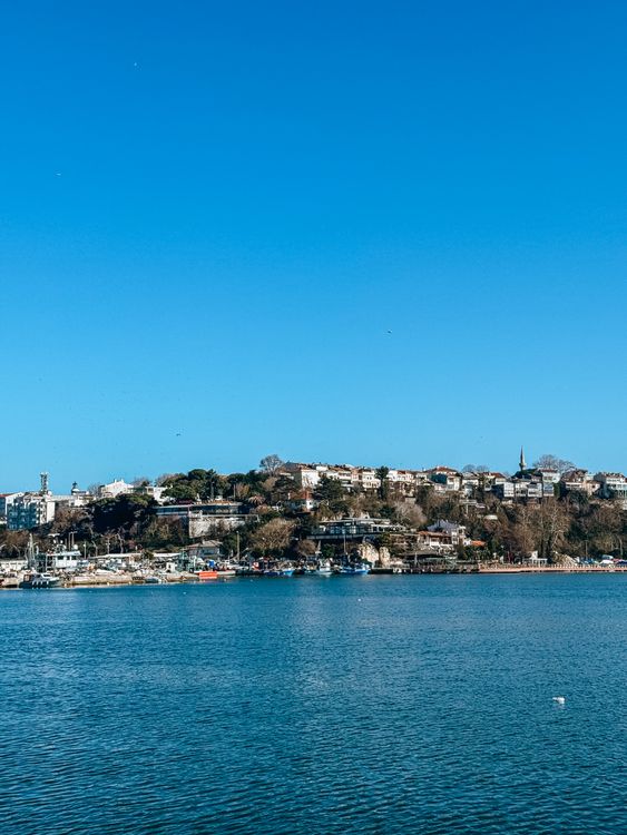 Scenic View of Waterside Town Under Blue Sky · Free Stock Photo