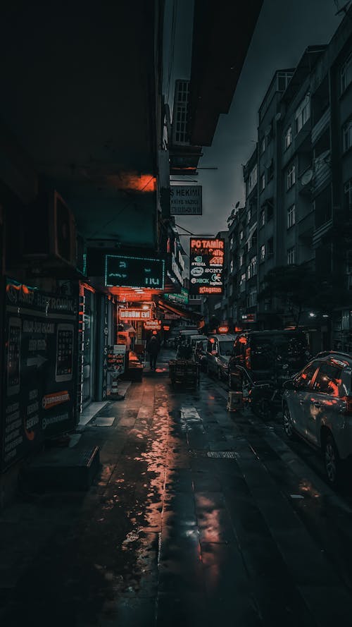 Free City street with cars and buildings at night Stock Photo