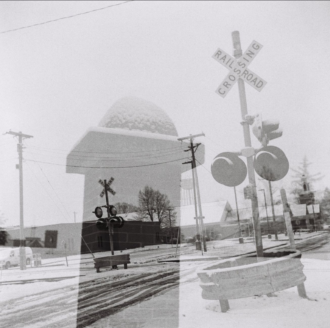 Double exposure of a snowy railroad crossing in Clinton, IL, creating a vintage effect.