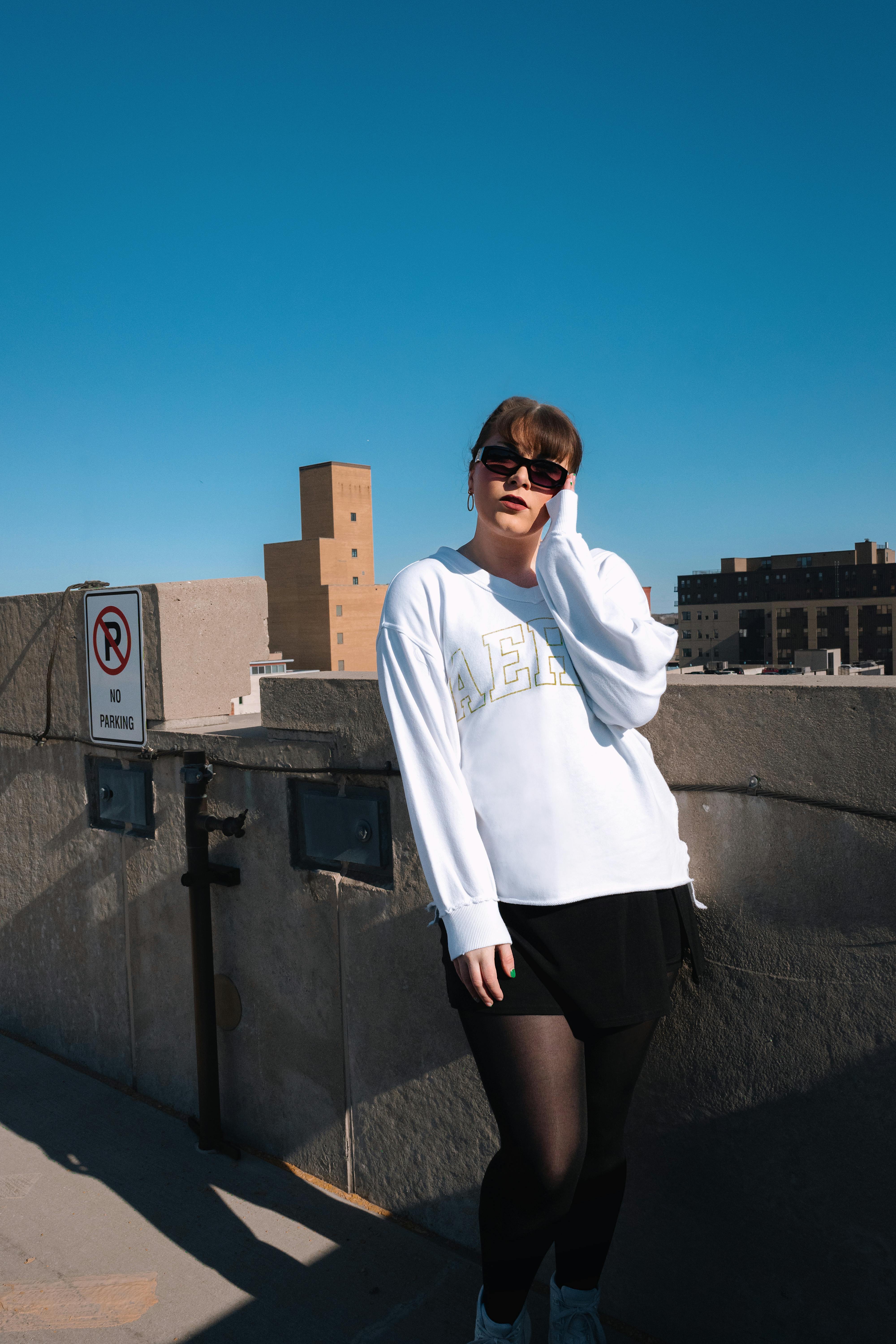 Young woman in urban environment wearing trendy fashion, capturing city vibes.