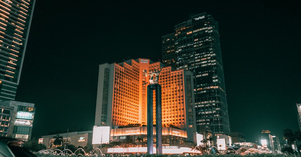 Urban nightscape featuring iconic Plaza Indonesia and landmark in Jakarta, Indonesia.
