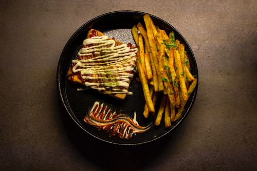 Free Delicious Iranian sandwich with crispy french fries garnished with parsley, perfect street food. Stock Photo