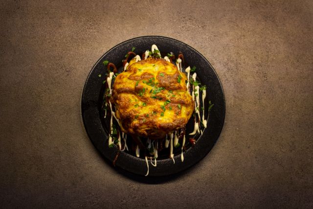 A mouthwatering baked lasagna artfully presented with sauces, highlighting Italian cuisine.