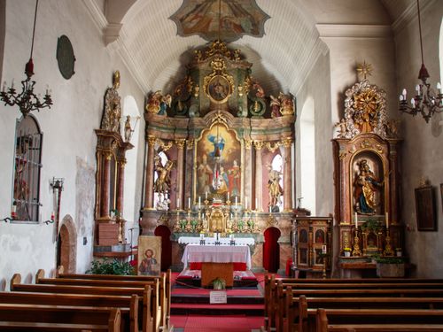 Free Intricately designed baroque church interior with a richly decorated altar and religious icons. Stock Photo