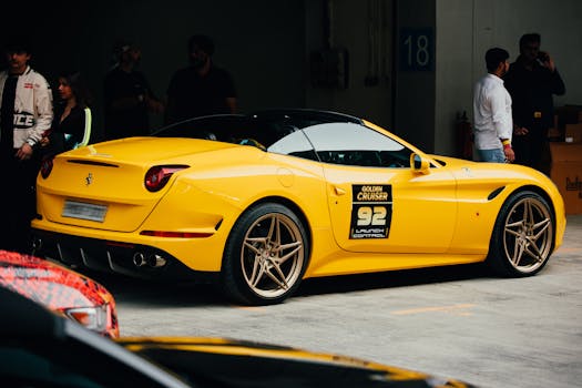 Bright yellow sports car parked in an indoor garage setting with people around in Greater Noida.