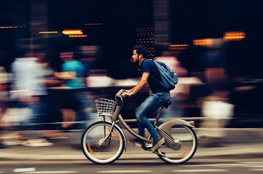 Man Riding Bicycle on City Street 